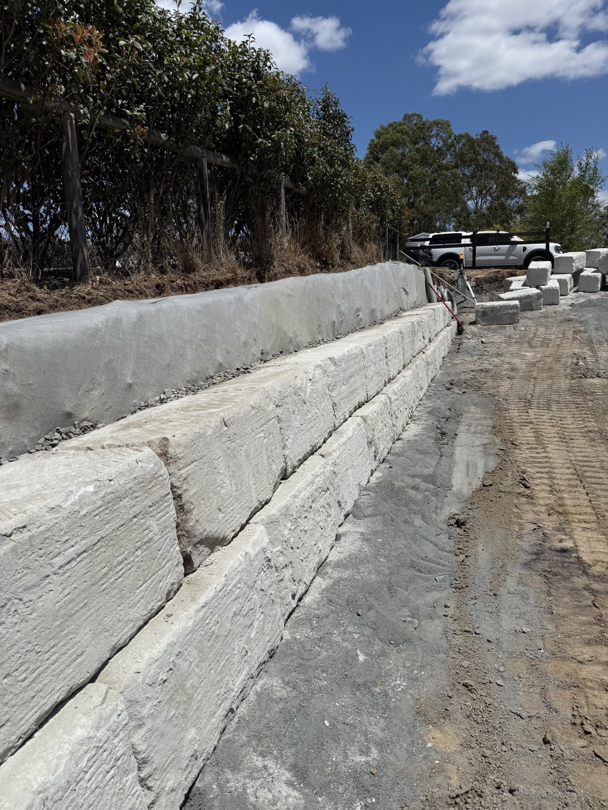 Completed sandstone retaining wall and graded driveway at Jimboomba property